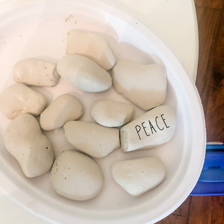 White rocks with the word "peace" transferred onto one rock