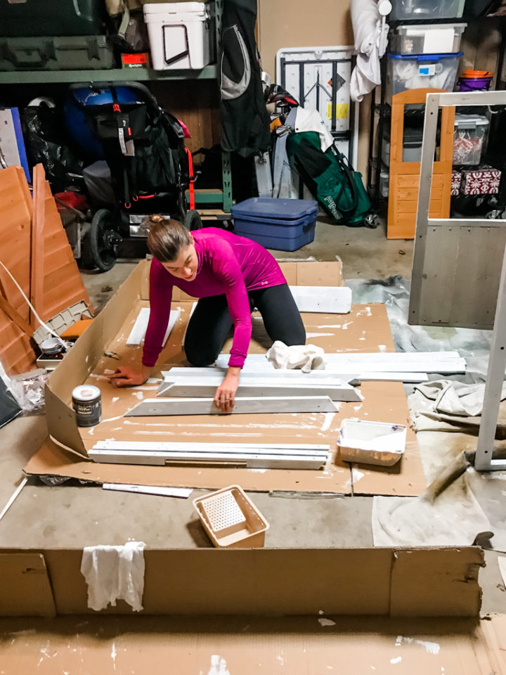My friend meredith helping me prime the playhouse parts