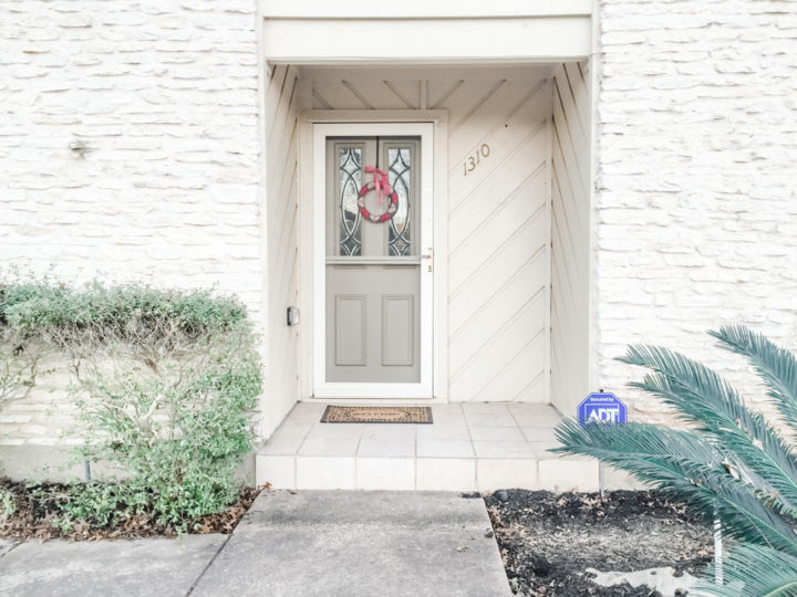 Beige front door with storm door.