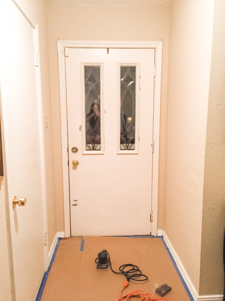 Paint prep for front door with floors covered in kraft paper